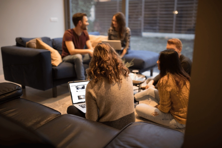 group of residents working together in a co-living space on couches